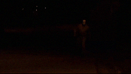 GIF from Extraction. Masky walks towards the camera with footage of Tim overlaid.